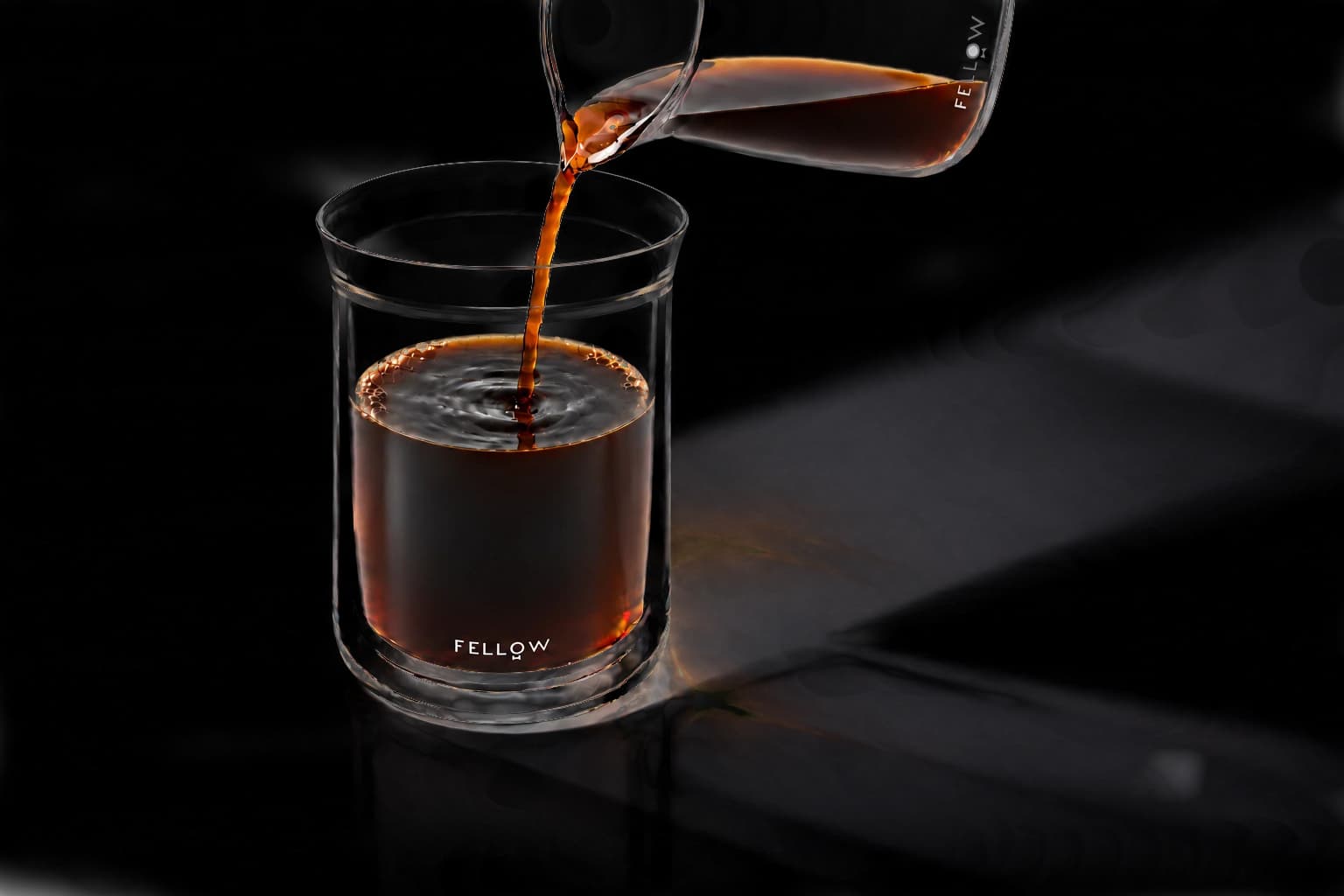 Fresh coffee pouring into a glass